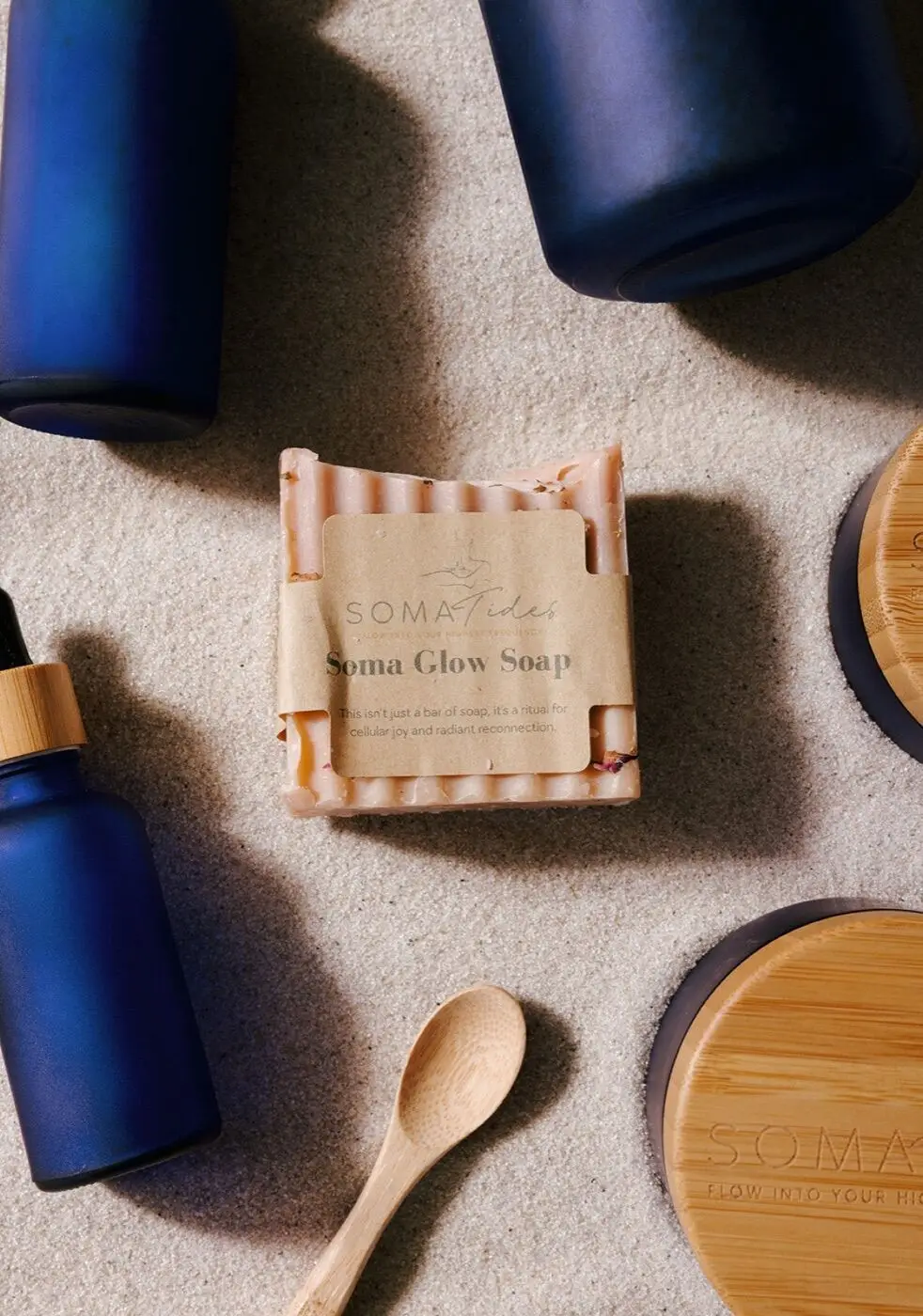 The Soma Tides Ritual Bundle — botanical soap, body butter, bath salts, anointment oil and mist on sand